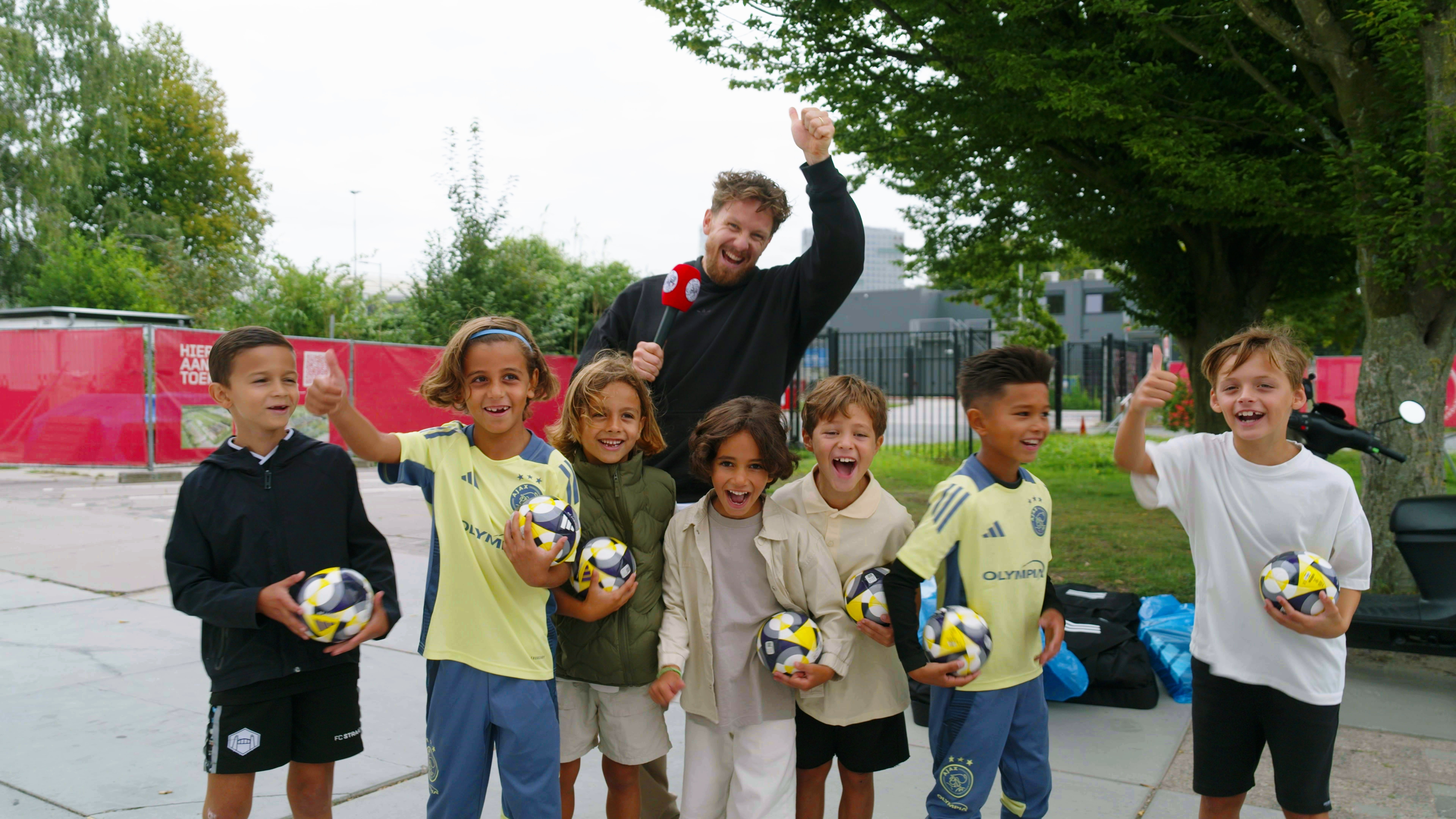 Lots of excitement at kit distribution, youngest Ajax players wide-eyed